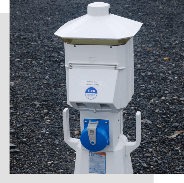 A white and blue parking meter on the side of road.